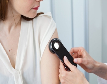 Doctor inspecting patient's skin